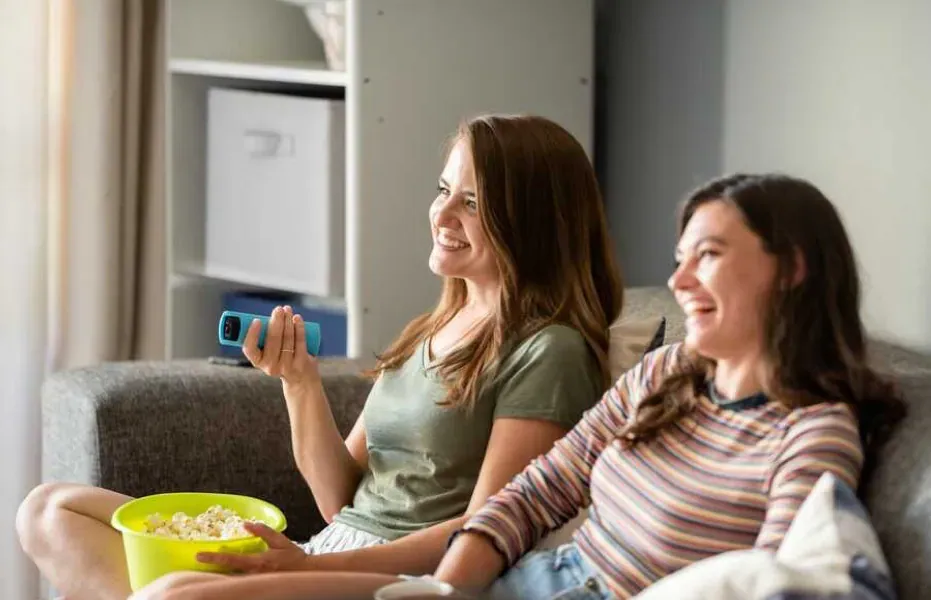 Mother and daughter watch television together